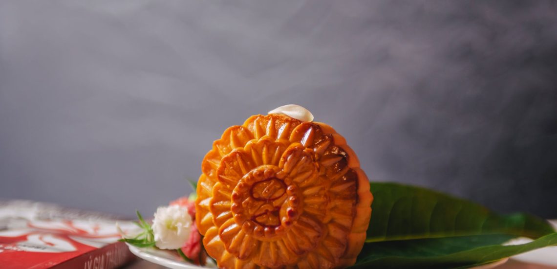 orange cookie with flowers on white ceramic plate